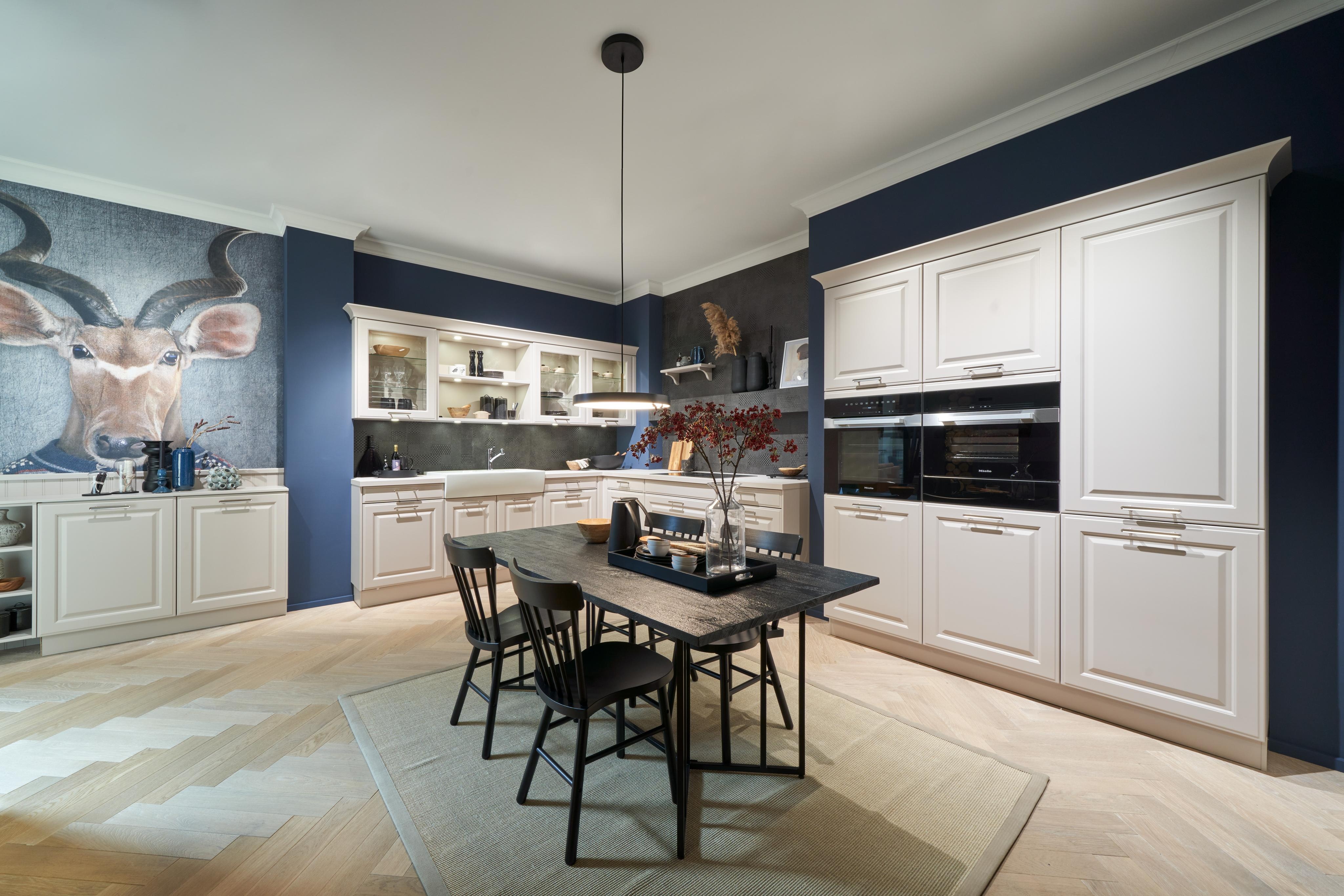 Helle Landhausküche in L-Form mit einem separaten Hochschrankblock und einem Tisch