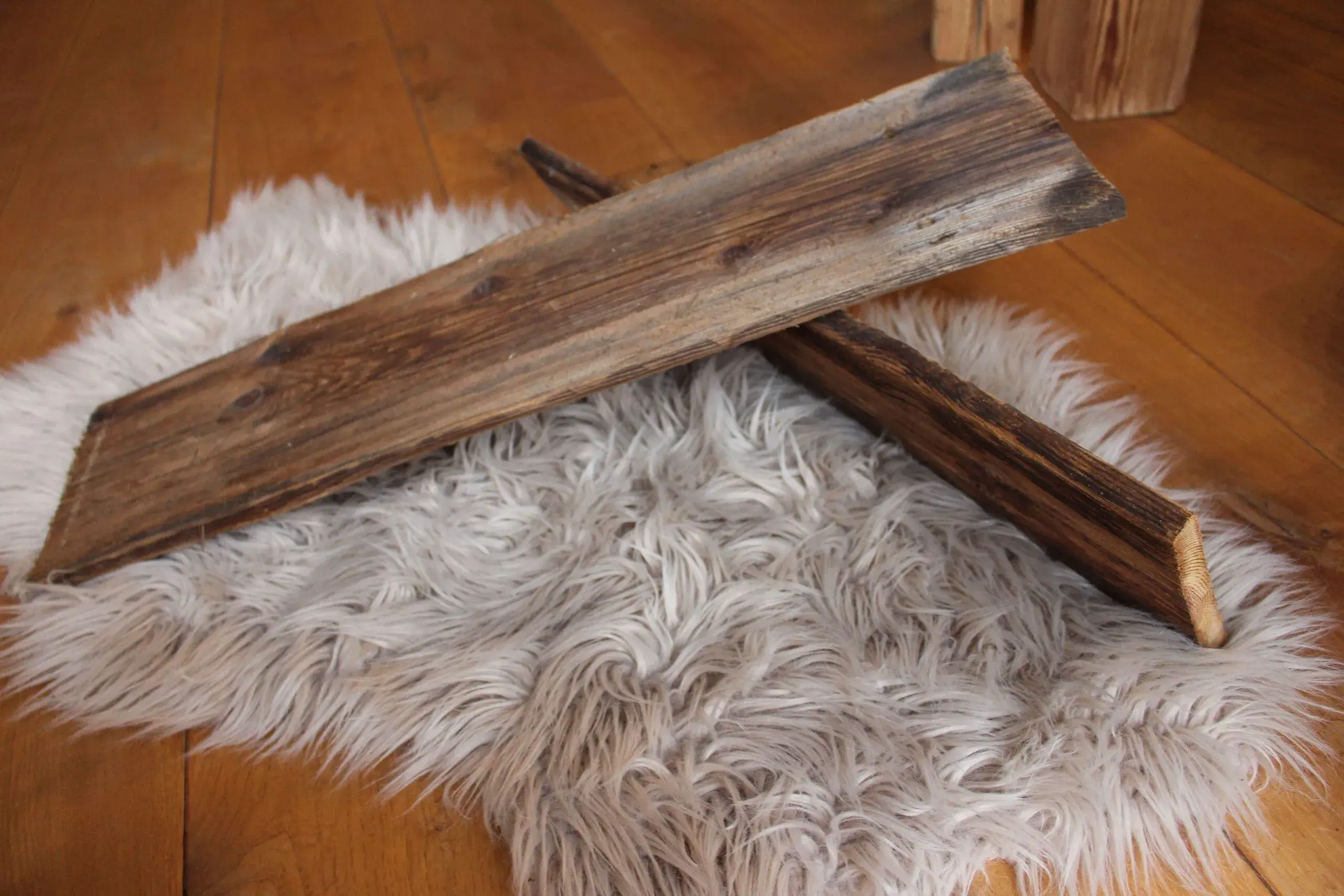 Zwei Holzscheite auf einem Teppich